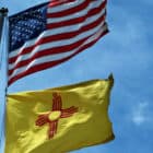 The flags of the United States and, below it, New Mexico.